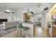 Open kitchen and dining area features bar seating, tile flooring, and views of the living room at 642 Boundary Blvd, Rotonda West, FL 33947