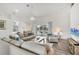 Open-concept living room with wood floors, bright natural light, comfortable seating, and sliding glass doors to the lanai at 642 Boundary Blvd, Rotonda West, FL 33947