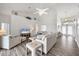 Spacious living room with high ceilings, light walls, wood floors, comfortable seating, and a decorative plant shelf at 642 Boundary Blvd, Rotonda West, FL 33947