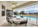 Relaxing screened-in pool patio with ceiling fan and outdoor seating for entertaining guests at 642 Boundary Blvd, Rotonda West, FL 33947