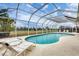 Gorgeous screened-in pool area with lounge chairs to enjoy the outdoors at 642 Boundary Blvd, Rotonda West, FL 33947