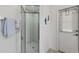 Modern shower with a glass door, complemented by adjacent towel rack and exterior access at 642 Boundary Blvd, Rotonda West, FL 33947