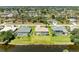 An aerial view of several beautiful homes, some with pools, near a lake at 68 Long Meadow Ln, Rotonda West, FL 33947