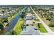 Beautiful aerial view of canal-front homes with screened pools and lush landscaping in a desirable neighborhood at 68 Long Meadow Ln, Rotonda West, FL 33947