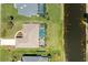 Aerial view of a house with a screen enclosed pool with a lake in the background at 68 Long Meadow Ln, Rotonda West, FL 33947