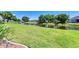 Lush backyard with well-maintained lawn and scenic canal view, providing a tranquil outdoor space at 68 Long Meadow Ln, Rotonda West, FL 33947
