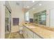 Bathroom with a granite-topped vanity, tiled floor, and glass-enclosed shower at 68 Long Meadow Ln, Rotonda West, FL 33947