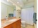 Bathroom with a granite-topped vanity, tiled floor, and shower curtain at 68 Long Meadow Ln, Rotonda West, FL 33947