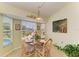 Cozy dining area with a beautiful view and a stylish glass top table at 68 Long Meadow Ln, Rotonda West, FL 33947