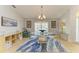 Dining room features a glass table set on an area rug, with ample shelving and natural light at 68 Long Meadow Ln, Rotonda West, FL 33947