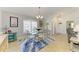 Cozy dining room with a glass table, shutters, and neutral paint color at 68 Long Meadow Ln, Rotonda West, FL 33947