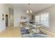 Bright dining room with a glass table and chairs, flooded with natural light from a nearby window at 68 Long Meadow Ln, Rotonda West, FL 33947