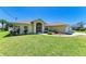 Charming single-story home featuring a well-manicured lawn and a screened entryway at 68 Long Meadow Ln, Rotonda West, FL 33947