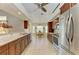 Open kitchen design with wood cabinets, stainless steel appliances, and a view to the dining area at 68 Long Meadow Ln, Rotonda West, FL 33947