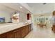 Bright kitchen with granite countertops, stainless appliances, and open dining area at 68 Long Meadow Ln, Rotonda West, FL 33947