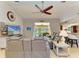 Comfortable living room with tile floors, ceiling fan, and bar seating to the kitchen at 68 Long Meadow Ln, Rotonda West, FL 33947