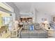 Open living room with tile floors, bar seating, and direct access to the outdoor pool area at 68 Long Meadow Ln, Rotonda West, FL 33947