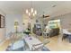 Spacious living and dining area with comfortable seating and a large ceiling fan at 68 Long Meadow Ln, Rotonda West, FL 33947