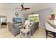 Open living room featuring tile floors, bar seating, and access to the pool and patio at 68 Long Meadow Ln, Rotonda West, FL 33947