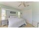 Bright main bedroom with neutral walls, a ceiling fan, closet, and two bedside tables at 68 Long Meadow Ln, Rotonda West, FL 33947