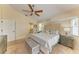 A comfortable main bedroom with a seating area, ceiling fan, and soft carpet at 68 Long Meadow Ln, Rotonda West, FL 33947