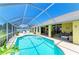 Gorgeous backyard oasis featuring a private pool, screened lanai, and lush landscaping for outdoor enjoyment at 68 Long Meadow Ln, Rotonda West, FL 33947