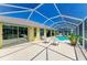 Spacious screened-in pool area with comfortable seating, ideal for outdoor entertaining and enjoying sunny days at 68 Long Meadow Ln, Rotonda West, FL 33947