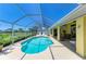 Backyard pool area with ample deck space, barbecue, and comfortable seating under a screened enclosure at 68 Long Meadow Ln, Rotonda West, FL 33947