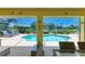 Relaxing screened lanai with view of sparkling pool and lush backyard, ideal for outdoor enjoyment at 68 Long Meadow Ln, Rotonda West, FL 33947