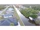 Aerial view of waterfront neighborhood, canal, boat dock, and lush foliage in neighborhood at 725 Clearview Dr, Port Charlotte, FL 33953