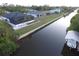 Scenic aerial view showcasing a waterfront home, canal, boat dock and surrounding neighborhood at 725 Clearview Dr, Port Charlotte, FL 33953