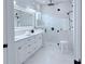 Modern bathroom with a large, glass-enclosed shower, dual sinks, and elegant marble tile at 725 Clearview Dr, Port Charlotte, FL 33953