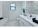 Bright bathroom features marble tiling, modern fixtures, and a sleek design at 725 Clearview Dr, Port Charlotte, FL 33953