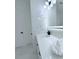 Sleek bathroom vanity featuring a modern light fixture, black faucet, and white marble-style countertops at 725 Clearview Dr, Port Charlotte, FL 33953