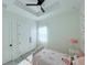 Sunlit bedroom features a tray ceiling, ceiling fan, and a large closet for storage at 725 Clearview Dr, Port Charlotte, FL 33953