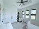 Sunlit Bedroom with a tray ceiling, ceiling fan, and plenty of storage space in the closet at 725 Clearview Dr, Port Charlotte, FL 33953