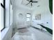 Bright Bedroom featuring a large window, ceiling fan, and an accent painting at 725 Clearview Dr, Port Charlotte, FL 33953