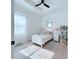 Bright bedroom featuring a black ceiling fan, white curtains, and accent decorations at 725 Clearview Dr, Port Charlotte, FL 33953