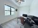 Office/Bedroom features a tray ceiling, large window, and light colored vinyl flooring at 725 Clearview Dr, Port Charlotte, FL 33953