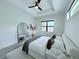 Spacious bedroom featuring a ceiling fan, soft lighting, and a large mirror at 725 Clearview Dr, Port Charlotte, FL 33953
