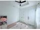 Bright bedroom featuring a ceiling fan, pink accent decorations, and lots of storage at 725 Clearview Dr, Port Charlotte, FL 33953