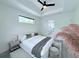 Beautiful bedroom featuring a ceiling fan, soft lighting, and a view of the outdoors at 725 Clearview Dr, Port Charlotte, FL 33953