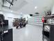 Spacious garage with epoxy flooring, shelving, and ample space for vehicles and storage at 725 Clearview Dr, Port Charlotte, FL 33953