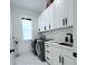 Well-organized laundry room with modern appliances, white cabinets, and ample countertop space at 725 Clearview Dr, Port Charlotte, FL 33953