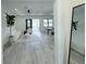 Bright and airy living room with stylish decor, wood flooring, and access to outdoor patio at 725 Clearview Dr, Port Charlotte, FL 33953