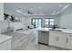 Bright open-concept living room with modern furniture, a ceiling fan, and sliding glass doors at 725 Clearview Dr, Port Charlotte, FL 33953