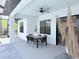 Outdoor patio featuring dining area, ceiling fan, and view of the landscaped backyard at 725 Clearview Dr, Port Charlotte, FL 33953