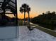 Patio view featuring sunset, landscaping and waterfront views, great for relaxing and entertaining at 725 Clearview Dr, Port Charlotte, FL 33953