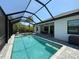 Inviting screened-in pool with spa, spacious deck, and stylish outdoor entertaining area at 725 Clearview Dr, Port Charlotte, FL 33953