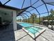 Beautiful screened-in pool and spa area overlooking the canal, perfect for relaxation at 725 Clearview Dr, Port Charlotte, FL 33953